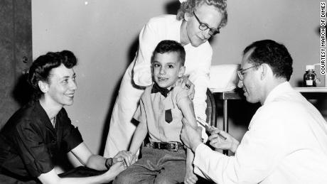 Dr. Jonas Salk gives his son, Darrell, the polio vaccine as his mother looks on in the 1950s. 