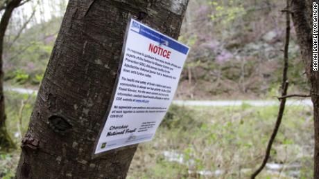 A notice is posted along a portion of the Appalachian Trail in Cosby, Tennessee, in late March 2020. Hikers were asked to leave the area as trailheads continued to close due to the coronavirus outbreak. 