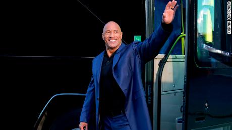 Dwayne Johnson waves to supporters in a scene from NBC&#39;s &quot;Young Rock.&quot; 