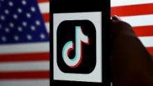 In this photo illustration, the social media application logo, TikTok is displayed on the screen of an iPhone on an American flag background on August 3, 2020 in Arlington, Virginia. - President Donald Trump said Monday that Chinese-owned hugely popular video-sharing app TikTok will be &quot;out of business&quot; in the United States if not sold to a US firm by September 15, 2020.&quot;I set a date of around September 15, at which point it&#39;s going to be out of business in the United States,&quot; he told reporters. (Photo by Olivier DOULIERY / AFP) (Photo by OLIVIER DOULIERY/AFP via Getty Images)