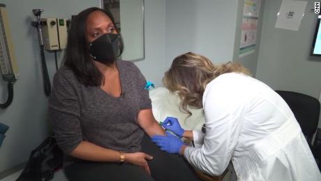 Elam prepares to get her blood drawn by nurse practitioner Amber Mottola.