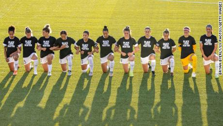 North Carolina Courage players kneel during the national anthem during a game against the Washington Spirit.