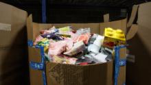 One of many large boxes of returned products that fill the warehouse. The returned products in this box will eventually be sorted and categorized.