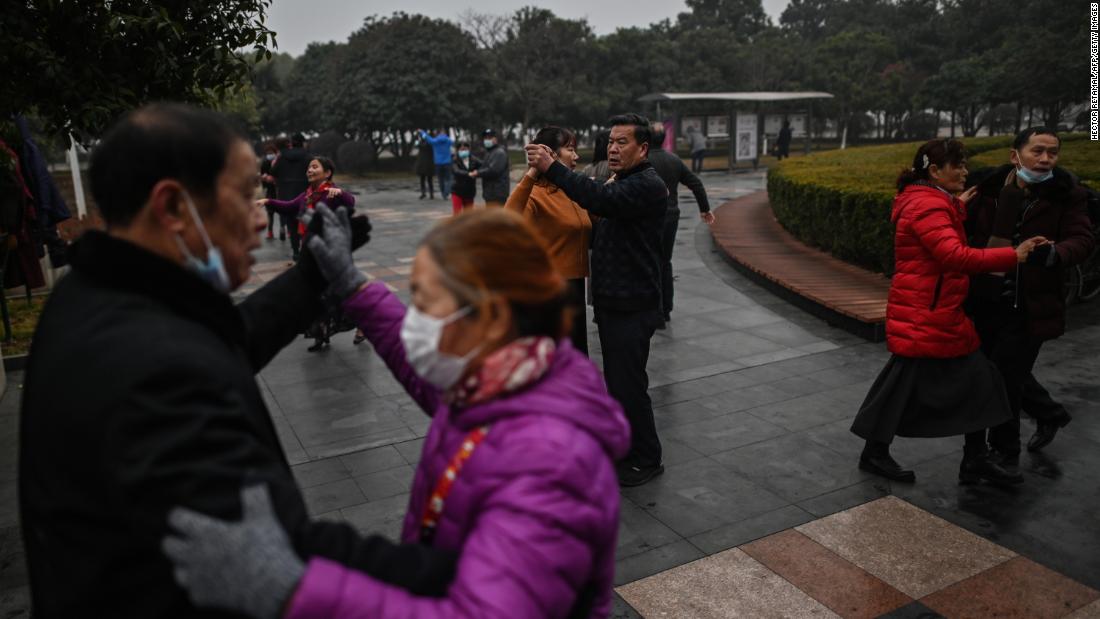 People dance in a park in Wuhan, China, on January 23, a year after the city went into lockdown to curb the spread of Covid-19.