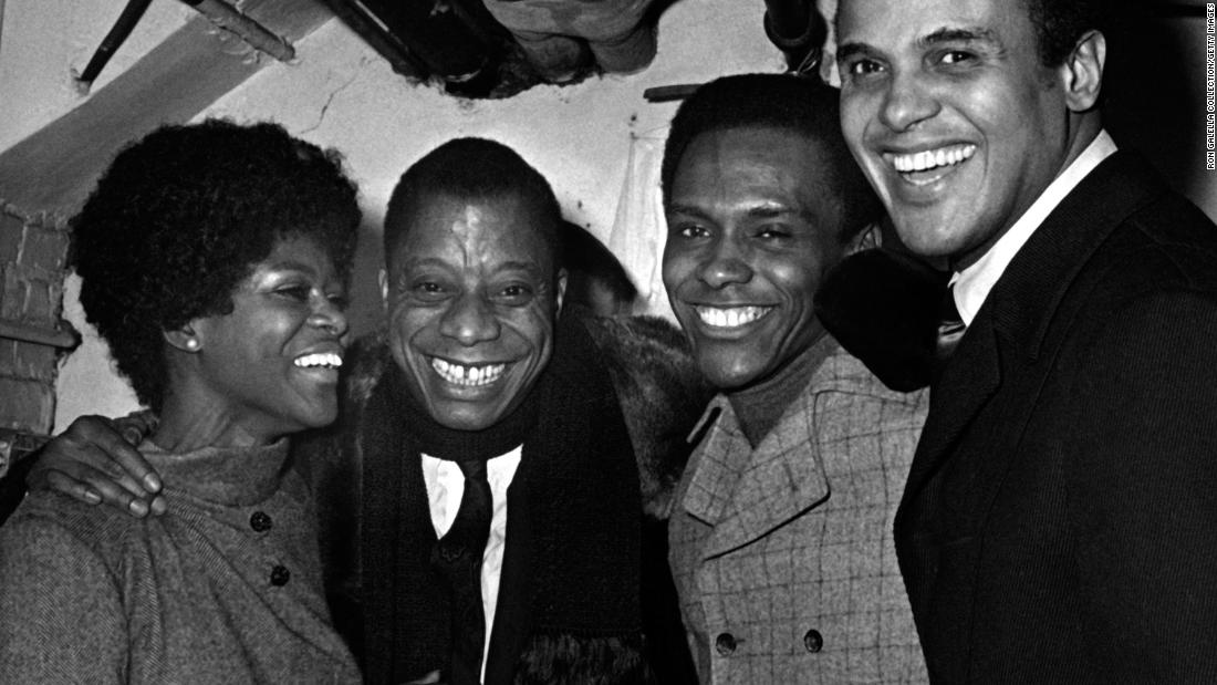 Tyson attends the To Be Young, Gifted and Black Gala in New York in 1969. Novelist James Baldwin is next to Tyson. Singer Harry Belafonte is on the right.