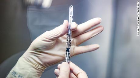 Rocky Mountain Regional VA Medical Center investigational pharmacy technician Sara Berech prepares a dose of the Johnson &amp; Johnson Covid-19 vaccine for a clinical trial on December 15, 2020 in Aurora, Colorado. 