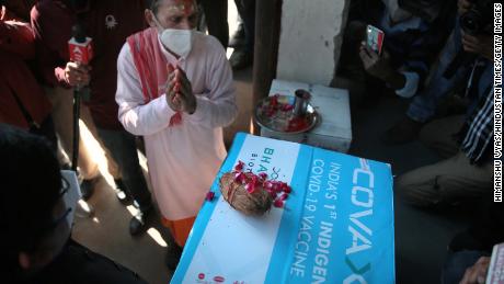 A priest performs prayer rituals on a carton containing the first consignment of Bharat Biotech&#39;s Covaxin vaccine.