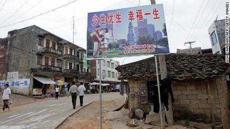 A one-child policy billboard saying, &quot;Have less children, have a better life&quot; greets residents on the main street of Shuangwang in southern China in 2007. 