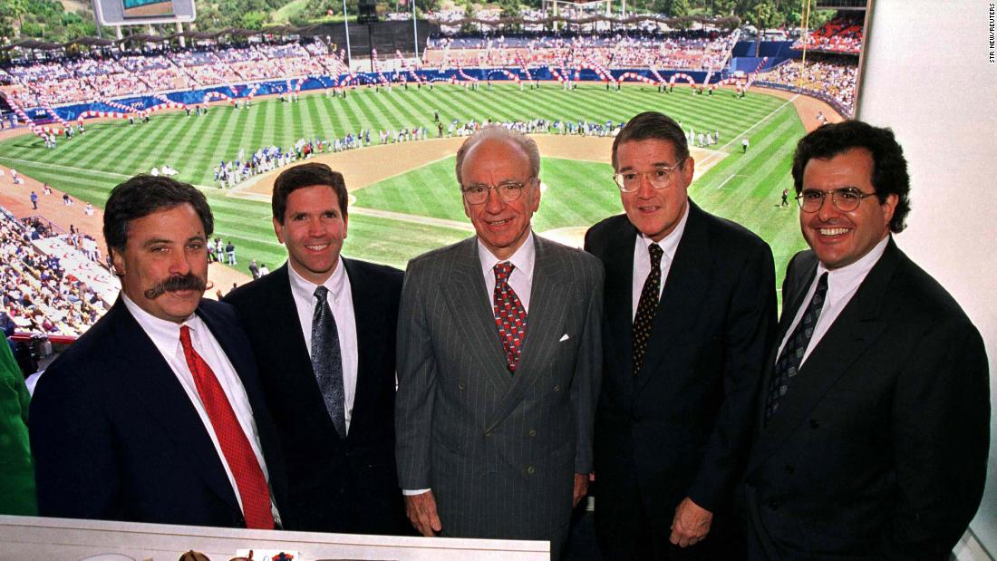 Murdoch, center, poses from the owners box at Dodger Stadium in 1998. From 1998 to 2004, Murdoch owned the Los Angeles Dodgers baseball team.