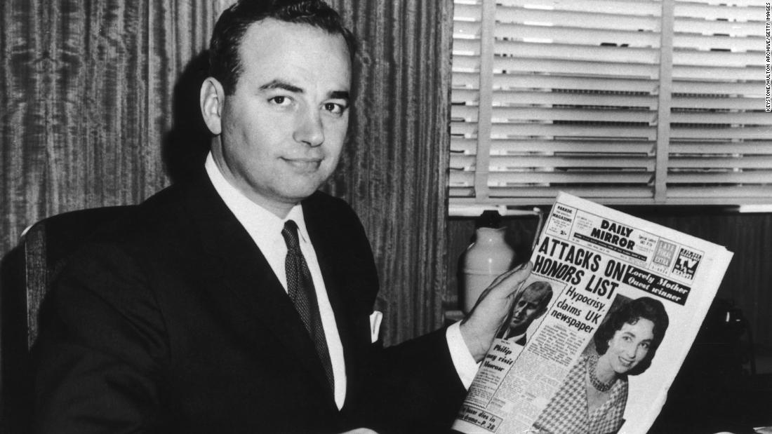 Murdoch holds a copy of the Sydney tabloid the Daily Mirror in 1960. He bought the newspaper that year. Murdoch was just 22 years old when he inherited the newspaper publishing company owned by his father, Keith. &quot;I was raised in a newspaper family by a father who believed that the newspaper was among the most important instruments of human freedom,&quot; Murdoch said in 2008.