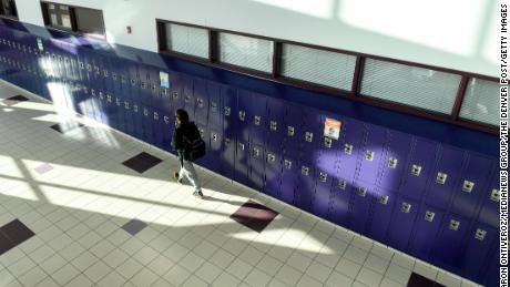 A student walks the halls between classes on January 25, the first day of in-person learning at Arvada West High School in Colorado.