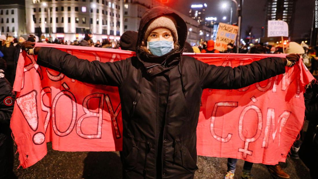 Protester Julia, 23, carries a banner at the protest. 