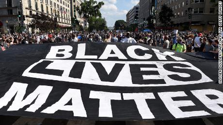 Protesters deploy a &quot;Black Lives Matter&quot; banner near the White House during a demonstration against racism and police brutality, in Washington, DC, on June 6, 2020. 