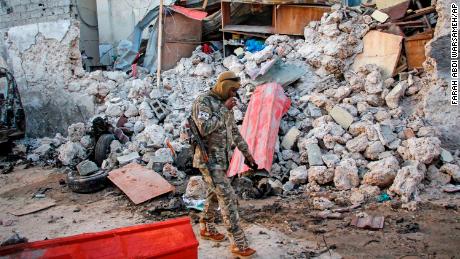 A soldier walks past wreckage in the aftermath of an attack on the Afrik hotel in Mogadishu