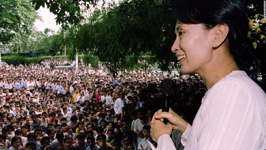 Suu Kyi speaks to hundreds of supporters from the gate at her residential compound in Yangon in 1995. She had just been released from house arrest, but her political activity was restricted.