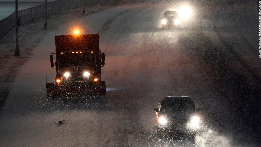 A truck salts Route 120 near MetLife Stadium in East Rutherford, New Jersey, on Sunday night.