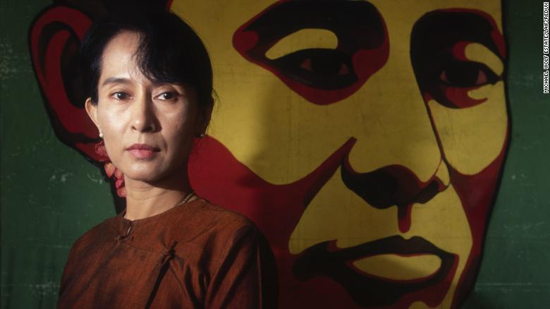 Suu Kyi poses in front of a portrait of her father in 1999. In 2000, she was once again placed under house arrest. 
