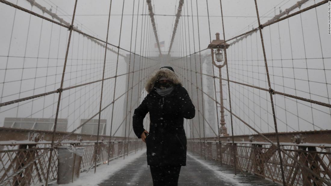 A person walks through New York&#39;s Brooklyn Bridge on Monday.