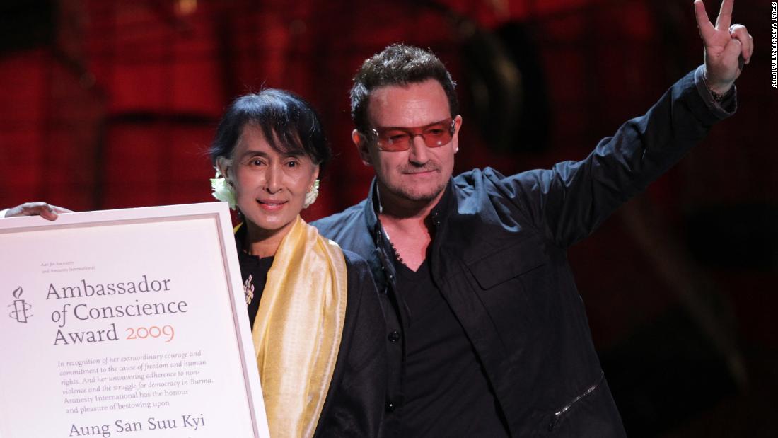 Suu Kyi accepts the Ambassador of Conscience Award next to U2 singer Bono during a European tour in 2012.