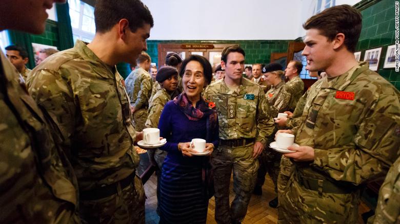 Suu Kyi joins officer cadets for tea while visiting a military academy in Camberley, England, in 2013.