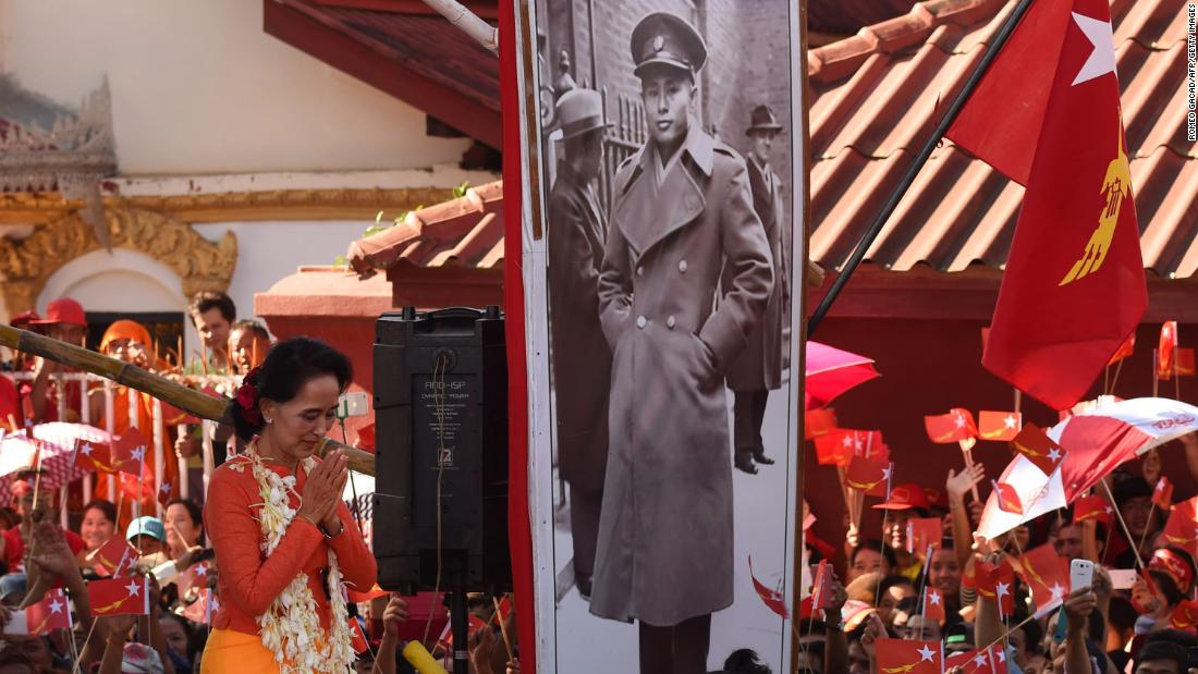 Suu Kyi descends from a stage decorated with a portrait of her late father during a campaign rally in 2015.