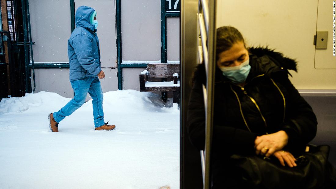 A commuter rests inside a New York subway car.