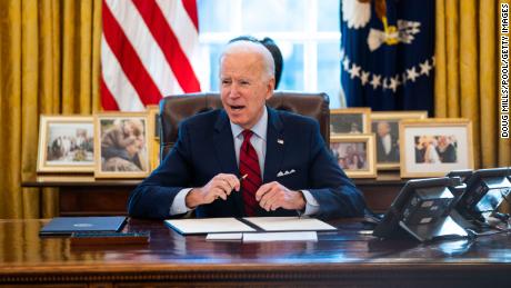 U.S. President Joe Biden signs executive actions in the Oval Office of the White House on January 28, 2021 in Washington, DC. Photo by Doug Mills-Pool/Getty Images