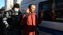 Law enforcement officers detain a man outside the Moscow City Court on Tuesday ahead of Navalny&#39;s hearing. 