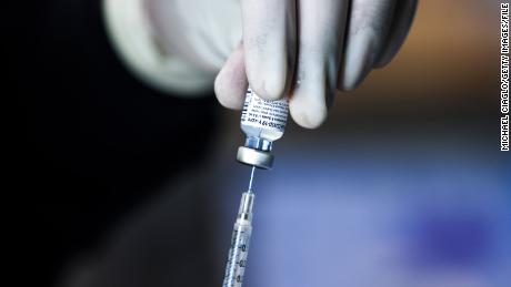 DENVER, CO - JANUARY 30: Pharmacy technicians prepare doses of the Pfizer-BioNTech vaccine at a mass COVID-19 vaccination event on January 30, 2021 in Denver, Colorado. UCHealth, Colorado&#39;s largest healthcare provider, plans to vaccinate 10,000 seniors over 70 during the drive-up event this weekend. (Photo by Michael Ciaglo/Getty Images)