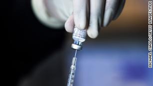 A pharmacy technician preps doses of the Pfizer-BioNTech vaccine at a mass Covid-19 vaccination event on January 30 in Denver.