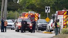 Law enforcement officers block an area where a shooting killed two FBI agents on Tuesday in Sunrise, Florida.