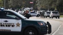 Law enforcement officers block off an area near where the agent deaths occurred in Sunrise, Florida.