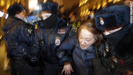 Police officers detain a Navalny supporter during a protest in St. Petersburg, Russia, on Tuesday.