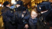 Police officers detain a Navalny supporter during a protest in St.  Petersburg on Tuesday.