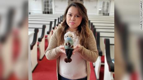 Chávez holds up the Bernie Sanders doll she crocheted.