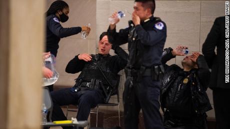 Capitol Police officers receive medical treatment after clashes with protesters attempting to disrupt the joint session of Congress to certify the Electoral College vote on Wednesday, January 6, 2021.