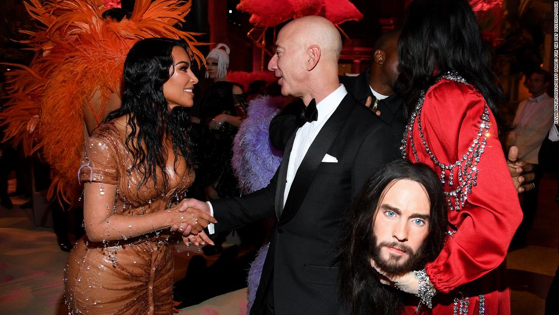 Bezos shakes hands with Kim Kardashian West while attending the Met Gala in New York in 2019. Actor Jared Leto is on the right.