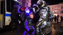 Riot police detain a protester after a court decision to imprison Alexey Navalny, in downtown Moscow in the early hours of Wednesday.