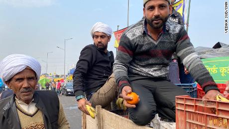 Farmers in Ghazipur gather fresh fruit from the back of a supply truck, on February 4, 2021.