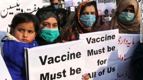 Women hold placards to demand the fair distribution of vaccines during a protest in Lahore, Pakistan, on January 29, 2021.