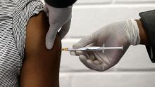 FILE - In this Wednesday, June 24, 2020 file photo, a volunteer receives an injection at the Chris Hani Baragwanath hospital in Soweto, Johannesburg, as part of Africa&#39;s first participation in a COVID-19 vaccine trial developed at the University of Oxford in Britain in conjunction with the pharmaceutical company AstraZeneca. On Friday, Oct. 23, 2020, AstraZeneca Inc. announced that the Food and Drug Administration is letting it resume testing of its COVID-19 vaccine candidate in the U.S. (Siphiwe Sibeko/Pool via AP)