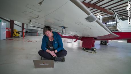 Mackenzie Smith, a senior scientist with Scientific Aviation, checks readings from the instruments that measure gases like methane in the atmosphere. 