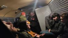 Detainees were forced to wait in cramped police vans as there is no space at detention centers.