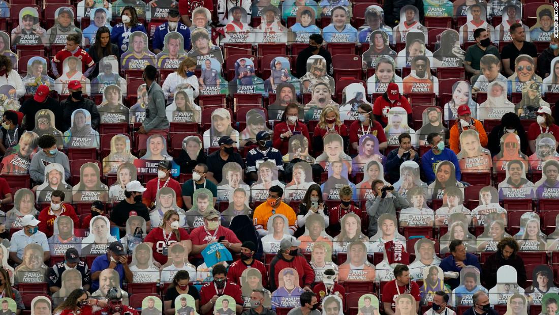Fans sit among cardboard cutouts before the game.