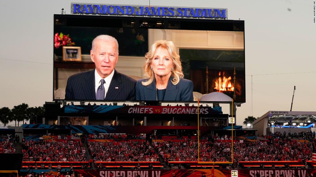 Fans at the stadium watch a pregame message from President Joe Biden and first lady Jill Biden.
