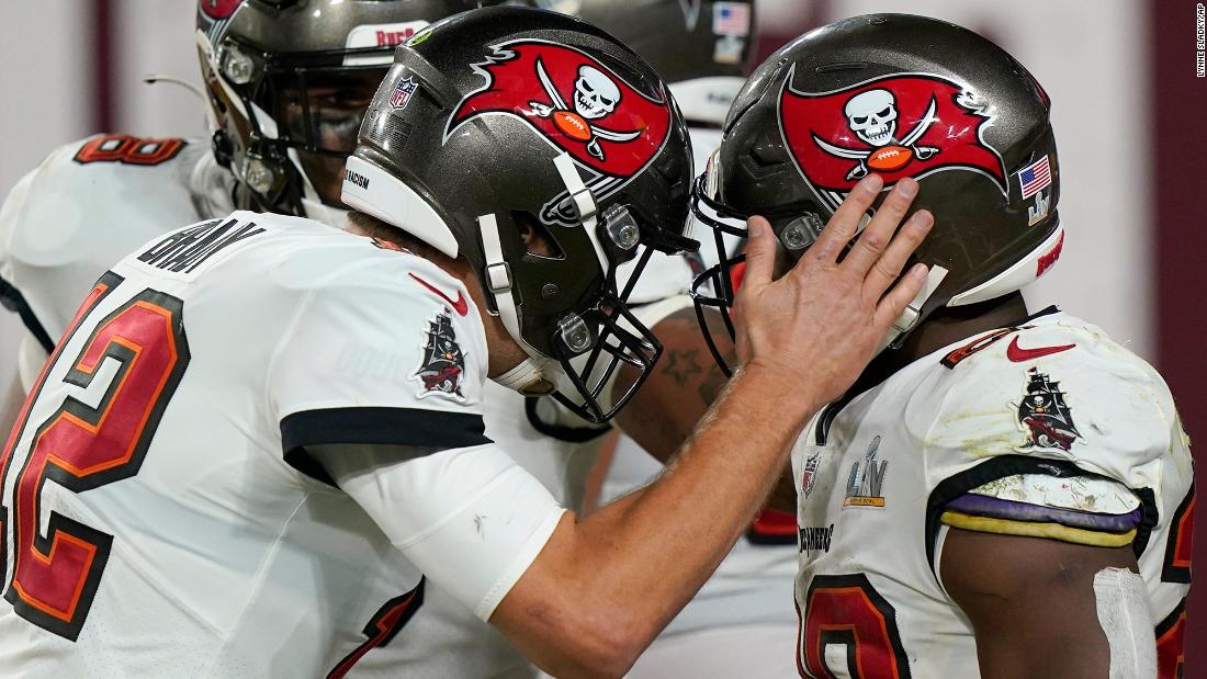 Brady congratulates Fournette after the touchdown run. The Buccaneers led 28-9 after the extra point.