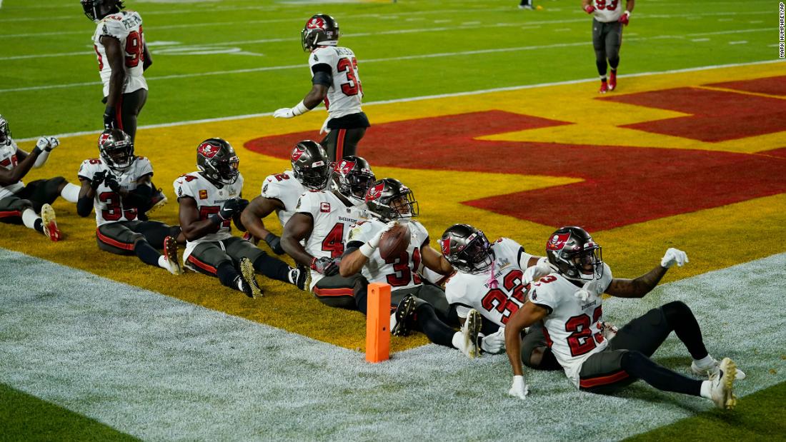 Tampa Bay players celebrate together after Winfield Jr. intercepted a Mahomes pass in the second half.