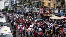 Protesters march through a street on February 8, 2021 in Yangon, Myanmar. 