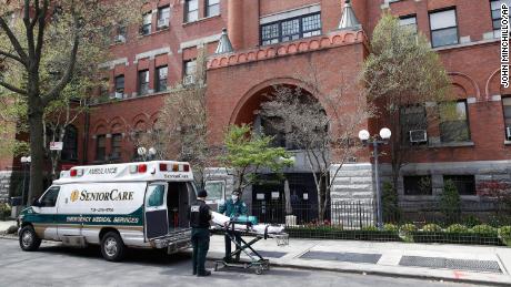 In this April 17, 2020, file photo, emergency medical workers arrive at Cobble Hill Health Center in the Brooklyn borough of New York.