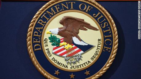 The Department of Justice seal is seen on a lectern ahead of a press conference on November 28, 2018. 